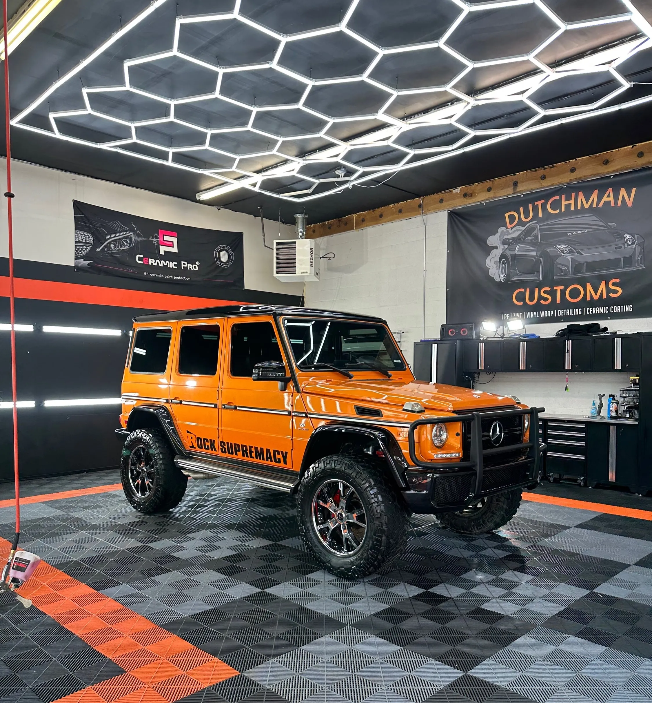 Orange Mercedes G-Wagon in the bay