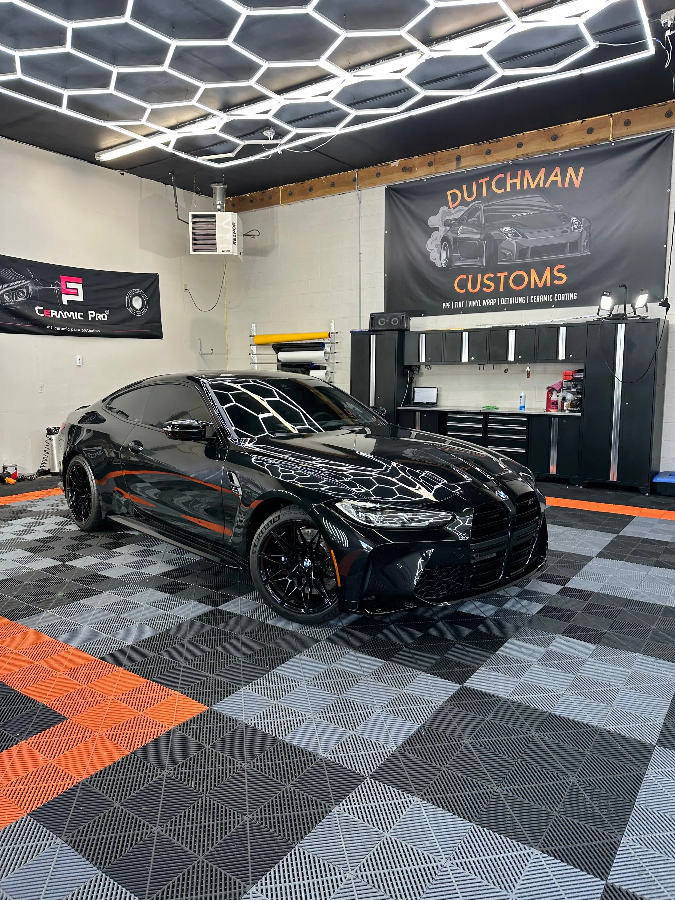 Black BMW M3 with dark tint in the bay