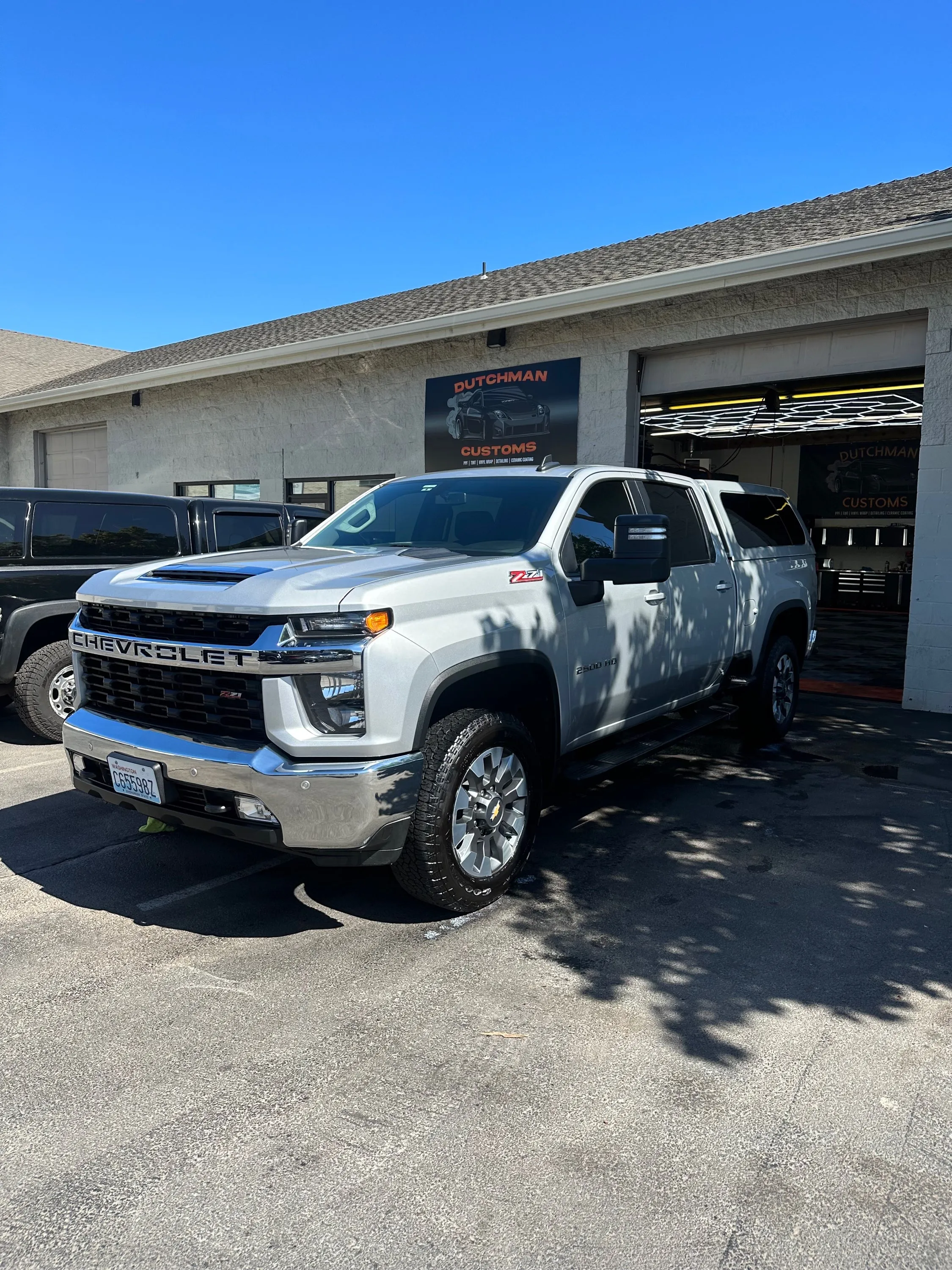 Chevy Silverado 2500 at the shop door